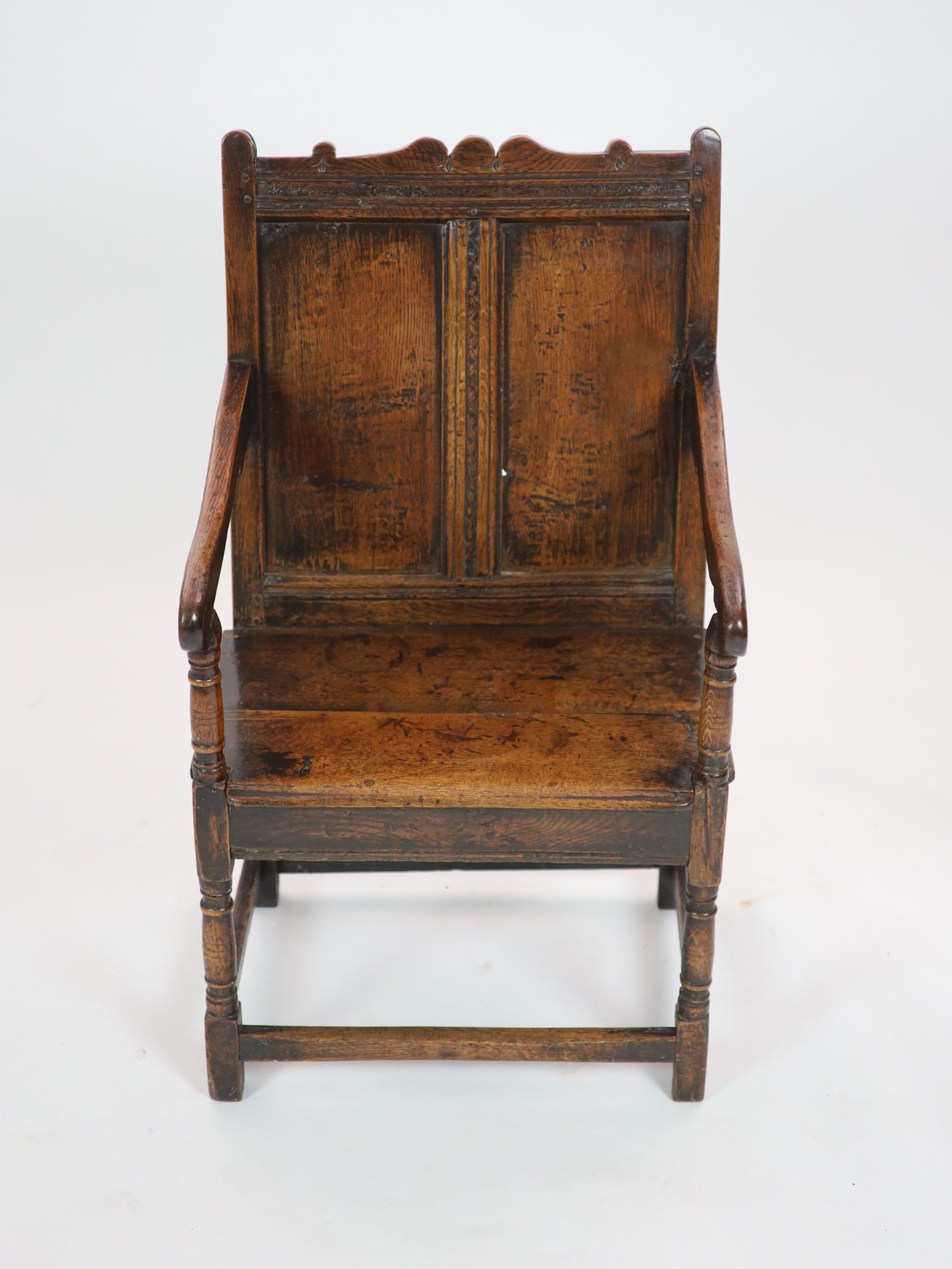A 17th century oak open armchair, H 103cm. W 60cm. D 54cm.